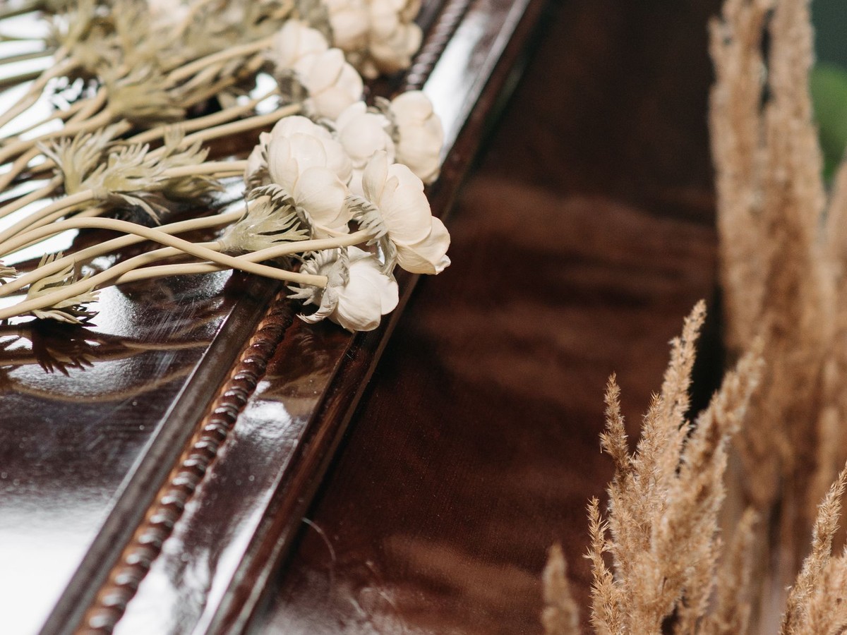 Funeral flowers on a wooden casket